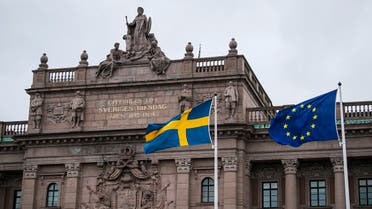 The Swedish and EU flags fly in front of the Swedish Parliament on April 16, 2020 in Stockholm. (AFP)