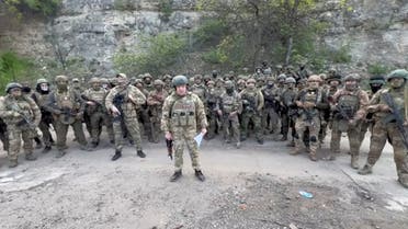 Founder of Wagner private mercenary group Yevgeny Prigozhin makes a statement as he stand next to Wagner fighters in an undisclosed location in the course of Russia-Ukraine conflict, in this still image taken from video released on May 5, 2023. (Reuters)
