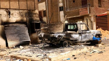 Damaged car and buildings are seen at the central market during clashes between the paramilitary Rapid Support Forces and the army in Khartoum North, Sudan, on April 27, 2023. (Reuters)