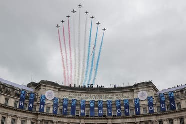 The British Royal Air Force's (RAF) aerobatic team, the Red Arrows, perform a fly-past over Admiralty Arch in central London on May 6, 2023, after the coronations of Britain's King Charles III and Britain's Queen Camilla. (AFP)