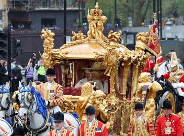 Britain's King Charles and Queen Camilla travel in the Gold State Coach past the Houses of Parliament and The Elizabeth Tower, more commonly known as Big Ben, following their coronation ceremony in London, Britain May 6, 2023. (Reuters)