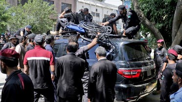 Pakistan security forces guard a vehicle carrying former Prime Minister Imran Khan after his arrest at a court in Islamabad, Pakistan, on May 9, 2023. (Reuters)