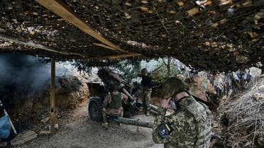 Ukrainian soldiers fire a cannon near Maryinka, an eastern city where fierce battles against Russian forces have been taking place, in the Donetsk region, Ukraine, Monday, May 8, 2023. (AP Photo/Libkos)