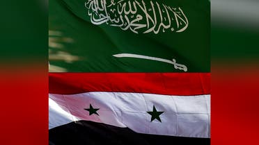 This combination of pictures created on March 23, 2023, shows A Saudi national flag in Riyadh on September 22, 2020 (top) and a Syrian national flag in Qamishli in the northeastern Hasakeh province on November 5, 2019. (AFP)