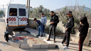 People stand near the site where two Palestinian Islamic Jihad gunmen were killed in an Israeli raid in Qabatiya, near Jenin, in the Israeli-occupied West Bank on May 10, 2023. (Reuters)