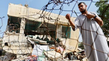 A man stands amid rubble after Islamic Jihad commander Ahmed Abu Daqqa was killed in an Israeli strike, in the southern Gaza Strip on May 11, 2023. (Reuters)