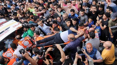 A man is carried on a stretcher following an Israeli strike that killed senior Islamic Jihad commander Eyad Al-Hasani in an apartment, in Gaza on May 12, 2023. (Reuters)