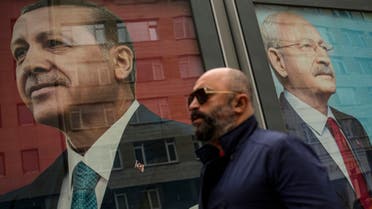 A man walks past election campaign billboards of Turkish President and People's Alliance's presidential candidate Recep Tayyip Erdogan, left, and CHP party leader and Nation Alliance's presidential candidate Kemal Kilicdaroglu in Istanbul, Turkey, Friday, May 5, 2023. (AP)