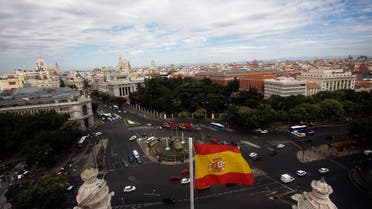 A Spanish flag flutters in the air as the capital of Spain is seen from the observatory deck of Madrid’s city hall on August 7, 2013. (Reuters)