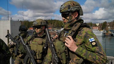 Finnish troops stand on a quay at a naval base in Berga, as they take part in a static display during a media visit to maneuvers with Finnish troops as part of Aurora 23, a Swedish military exercise involving more than 26,000 personnel, in Berga, Sweden, on April 28, 2023. (Reuters)