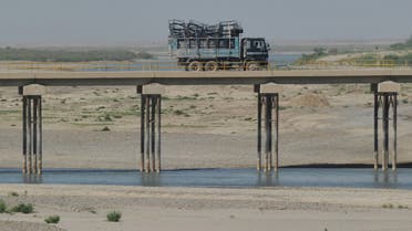 A truck is driven across a bridge spanning the Helmand river. (AFP)