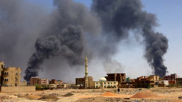 FILE PHOTO: FILE PHOTO: A man walks while smoke rises above buildings after aerial bombardment, during clashes between the paramilitary Rapid Support Forces and the army in Khartoum North, Sudan, May 1, 2023. REUTERS/Mohamed Nureldin Abdallah/File Photo/File Photo/File Photo