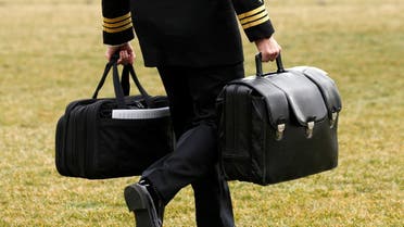 A military aide, carrying the football containing launch codes for nuclear weapons, accompanies the US president. (File Photo: Reuters)