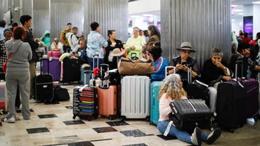 Passengers gather at Terminal 1 of Benito Juarez International Airport after authorities suspended the operations of the airport following the Popocatepetl volcano activity, in Mexico City, Mexico, May 20,2023. (Reuters)