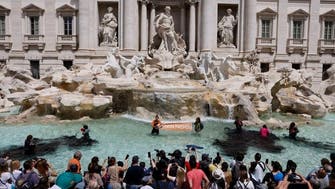 Activists turn Trevi Fountain water black in Rome climate protest