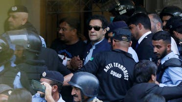 FILE PHOTO: Security officers escort Pakistan's former Prime Minister Imran Khan, as he appeared in Islamabad High Court, Islamabad, Pakistan May 12, 2023. REUTERS/Akhtar Soomro/File Photo
