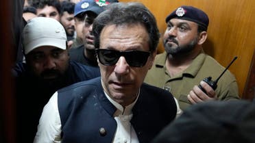 Former Pakistani Prime Minister Imran Khan, center, leaves court after an appearance in Lahore, Pakistan, Friday, May 19, 2023. Khan dialed down his campaign of defiance on Friday, saying he would allow a police search of his home over allegations that he was harboring suspects wanted in recent violence during anti-government protests by his supporters. (AP Photo/K.M. Chaudary)