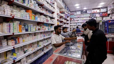 Customers buy medicine from a medical supply store in Karachi, Pakistan. (Reuters)
