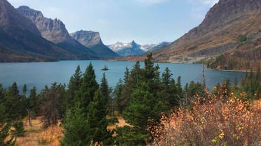 FILE - This Sept. 4, 2017 file photo shows a view from the Going-to-the-Sun Road in Glacier National Park in Montana, with a lake ringed by mountains and tall trees. Glacier National Park officials are teed off over a report that tourists were hitting golf balls off Going-to-the-Sun Road during a traffic delay. On Friday, July 19, 2019, Glacier spokeswoman Lauren Alley told the Missoulian the incident is under investigation. (AP Photo/Beth J. Harpaz, File)