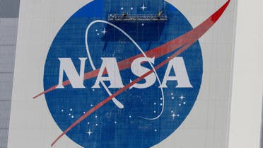 Workers pressure wash the logo of NASA on the Vehicle Assembly Building, in Cape Canaveral. (Reuters)