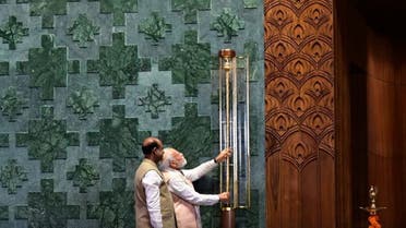 Indian prime minister Narendra Modi carries a royal golden sceptre to be installed it near the chair of the speaker during the start of the inaugural ceremony of the new parliament building, in New Delhi, India, Sunday, May 28, 2023. The new triangular parliament building, built at an estimated cost of $120 million, is part of a $2.8 billion revamp of British-era offices and residences in central New Delhi called Central Vista. (AP Photo) ASSOCIATED PRESS