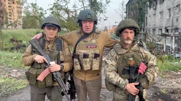 Founder of Wagner private mercenary group Yevgeny Prigozhin poses with mercenaries Biber and Dolik during a statement on the start of withdrawal of his forces from Bakhmut and handing over their positions to regular Russian troops, in the course of Russia-Ukraine conflict in Bakhmut, Ukraine, in this still image taken from video released May 25, 2023. Press service of Concord/Handout via REUTERS ATTENTION EDITORS - THIS IMAGE WAS PROVIDED BY A THIRD PARTY. NO RESALES. NO ARCHIVES. MANDATORY CREDIT. TPX IMAGES OF THE DAY