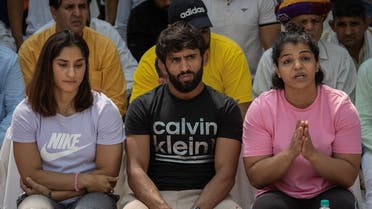 Indian wrestlers Vinesh Phogat, Bajrang Punia, and Sakshi Malik address a news conference as they take part in a sit-in protest demanding arrest of Wrestling Federation of India (WFI) chief, who they accuse of sexually harassing female players, in New Delhi, India, on April 24, 2023. (Reuters)
