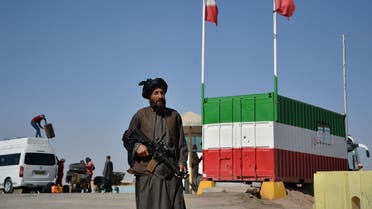 In this picture taken on October 19, 2021 a Taliban fighter stands guard at the Islam Qala border between Iran and Afghanistan. (AFP)