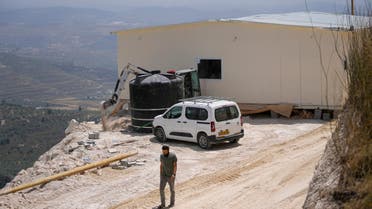 Jewish settlers work at a seminary under construction that was built overnight in the West Bank outpost of Homesh, Monday, May 29, 2023. (AP)