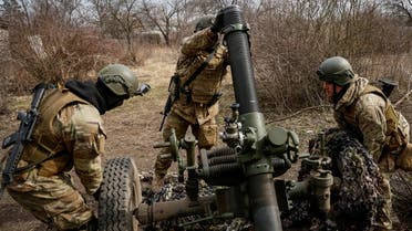 Service members with the Freedom of Russia Legion under the Ukrainian Army prepare to fire a mortar at a Russian military position, as Russia's invasion of Ukraine continues, in Donetsk region, Ukraine, March 21, 2023. (Reuters)