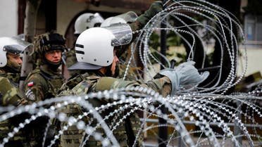Polish members of the NATO-led Kosovo Force (KFOR) set up a wire fencing as they stand guard near a municipal office in Zvecan, Kosovo, May 31, 2023. REUTERS/Ognen Teofilovski