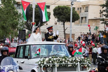 Jordan’s Crown Prince Hussein and Rajwa Al Saif travel in a convoy, on the day of their royal wedding in Amman, Jordan, on June 1, 2023. (Reuters)