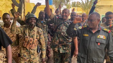 This picture released on the Sudanese Army's Facebook page on May 30, 2023, shows army chief Abdel Fattah al-Burhan cheering with soldiers as he visits some of their positions in Khartoum. (AFP)
