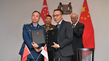 Chinese Defence Minister Li Shangfu and Singapore’s Defence Minister Ng Eng Hen witness the signing of a Memorandum of Understanding (MOU) between Singapore and China on the establishment of a bilateral defence hotline, in Singapore, June 1, 2023.  (Reuters)