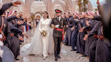 Jordan's Crown Prince Hussein and Rajwa Al Saif are greeted as they walk together on the day of their royal wedding, in Amman, Jordan, June 1, 2023. Royal Hashemite Court (RHC)/Handout via REUTERS ATTENTION EDITORS - THIS IMAGE WAS PROVIDED BY A THIRD PARTY.