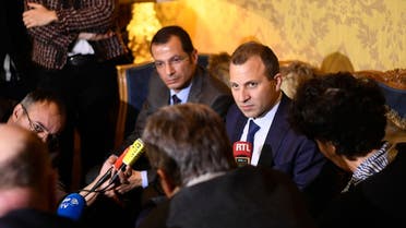 Then-Lebanese Foreign Minister Gebran Bassil (C) delivers a press conference at the Embassy of Lebanon in Paris in 2017. Rami Adwan, the Lebanese ambassador to France, is pictured to the left of Bassil. (AFP)