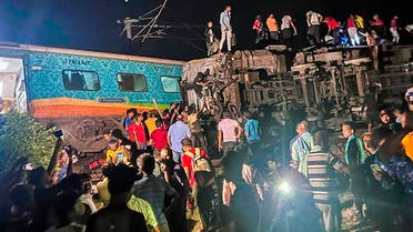 MANDATORY CREDIT- People inspect the site of passenger trains that derailed in Balasore district, in the eastern Indian state of Orissa, Friday, June 2, 2023. Two passenger trains derailed in India, killing at least 13 people and trapping hundreds of others inside more than a dozen damaged coaches, officials said. About 400 people were injured and taken to hospitals, and the cause of the accident was under investigation, officials said. (Press Trust of India via AP)