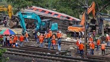 Heavy machinery remove damaged coaches from the railway tracks at the site of a train collision following the accident in Balasore district in the eastern state of Odisha, India, on June 4, 2023. (Reuters)