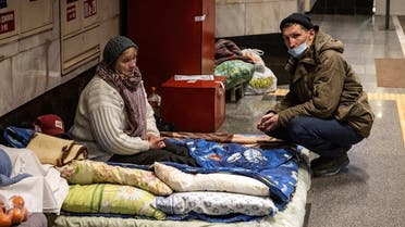 Residents take refuge in a metro station, being used as bomb shelter, in Kyiv on March 18, 2022. (AFP)