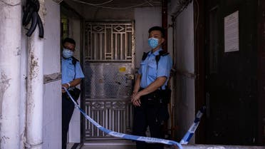 Police officers stand outside an apartment where three children were killed in Sham Shui Po in Hong Kong, Monday, June 5, 2023. (AP)