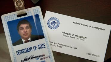 The identification and business card of former FBI agent Robert Hanssen are seen inside a display case at the FBI Academy in Quantico, Virginia, May 12, 2009. Hanssen was sentenced to life in prison without parole for spying for the Soviet Union and Russia while he worked for the FBI. AFP Photo/Paul J. Richards (Photo by PAUL J. RICHARDS / AFP) RELA