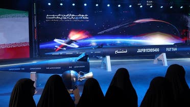 Women look at Fattah hypersonic missile in a ceremony in Tehran, Iran, Tuesday, June 6, 2023. (Tasnim News Agency via AP)