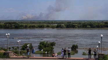 The Dnipro River which flooded after the Nova Kakhovka dam breached as smoke rises after shelling on the opposite bank, amid Russia's attack on Ukraine, in Kherson, Ukraine June 6, 2023. (Reuters)
