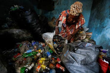 Fatimoh Adeosun, 48, a parent of a student of My Dream Stead, a low-cost school that accepts recyclable wastes as payment, sorts plastic waste for submission, in Ajegunle, Lagos, Nigeria May 19, 2023. (REUTERS)
