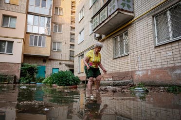 Oleksandra walks around her house on a flooded street, after the Nova Kakhovka dam breached, amid Russia's attack on Ukraine, in Kherson, Ukraine June 6, 2023. (Reuters)