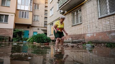 Oleksandra walks around her house on a flooded street, after the Nova Kakhovka dam breached, amid Russia's attack on Ukraine, in Kherson, Ukraine June 6, 2023. REUTERS