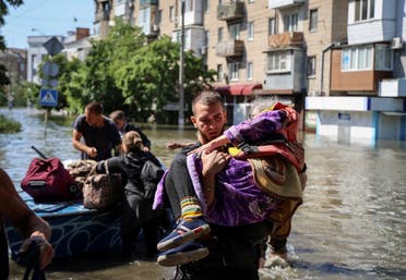 Police evacuate local residents from a flooded area after the Nova Kakhovka dam breached, amid Russia's attack on Ukraine, in Kherson, Ukraine June 7, 2023. (Reuters)