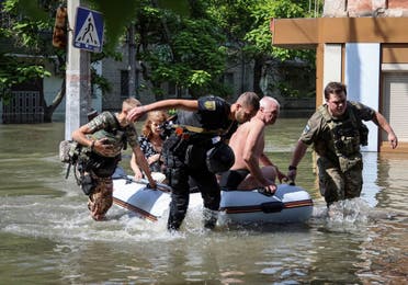 Police evacuate local residents from a flooded area after the Nova Kakhovka dam breached, amid Russia's attack on Ukraine, in Kherson, Ukraine June 7, 2023. (Reuters)