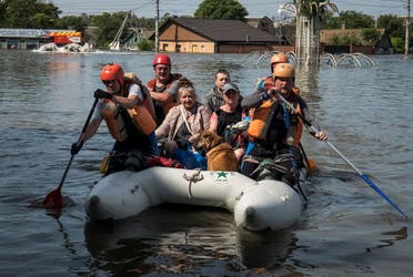 Rescuers evacuate local residents from a flooded area after the Nova Kakhovka dam breached, amid Russia's attack on Ukraine, in Kherson, Ukraine June 7, 2023. (Reuters)