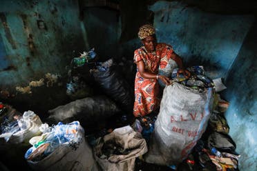 Fatimoh Adeosun, 48, a parent of a student of My Dream Stead, a low-cost school that accepts recyclable wastes as payment, sorts plastic waste for submission, in Ajegunle, Lagos, Nigeria May 19, 2023. (REUTERS)